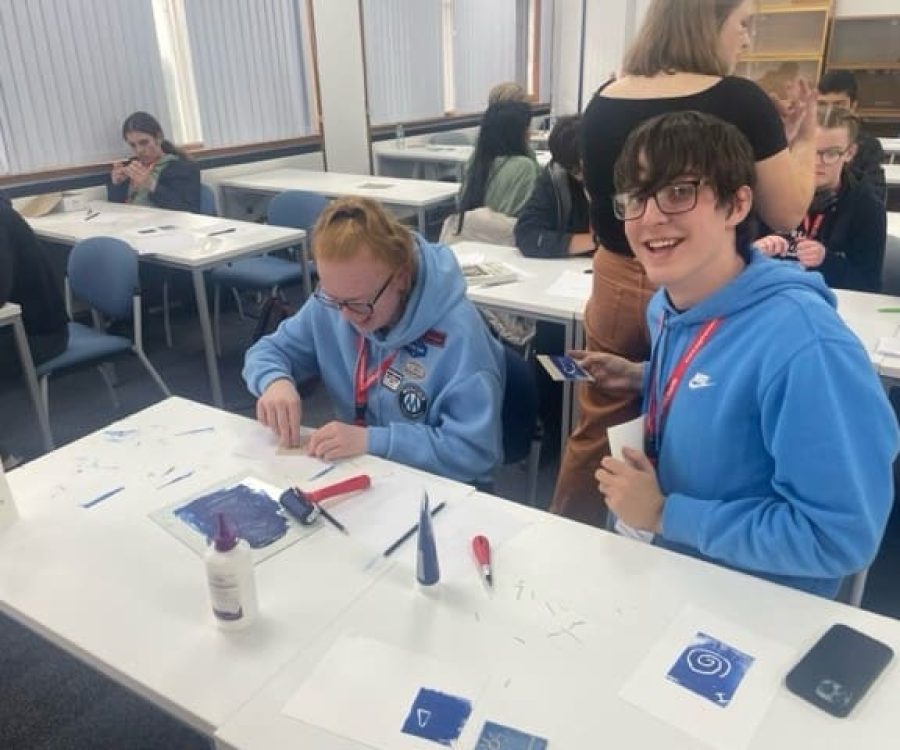 2 young people lino cutting in a classroom